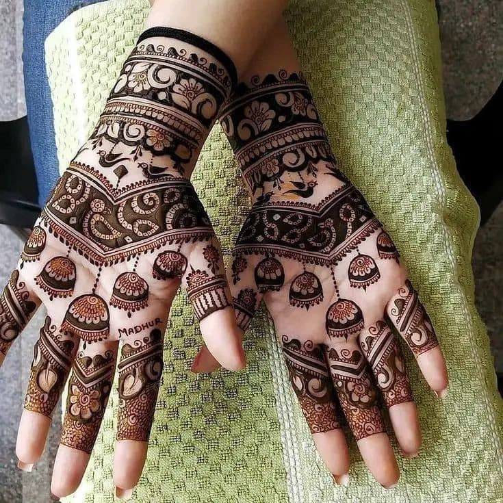 Engagement henna design with intricate paisley motifs and finger detailing