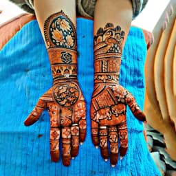 Elegant engagement mehndi design featuring intricate floral patterns for both hands