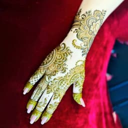 Stylish engagement mehndi design with decorative floral and paisley artwork