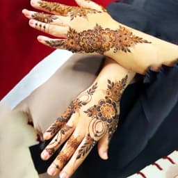 Traditional mehndi design with floral motifs covering the back of the hand